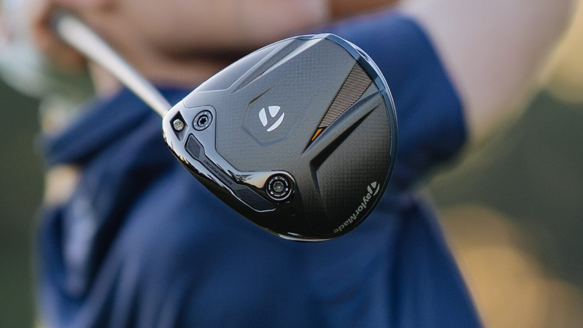 Close-up of a golf club head with a blurred background