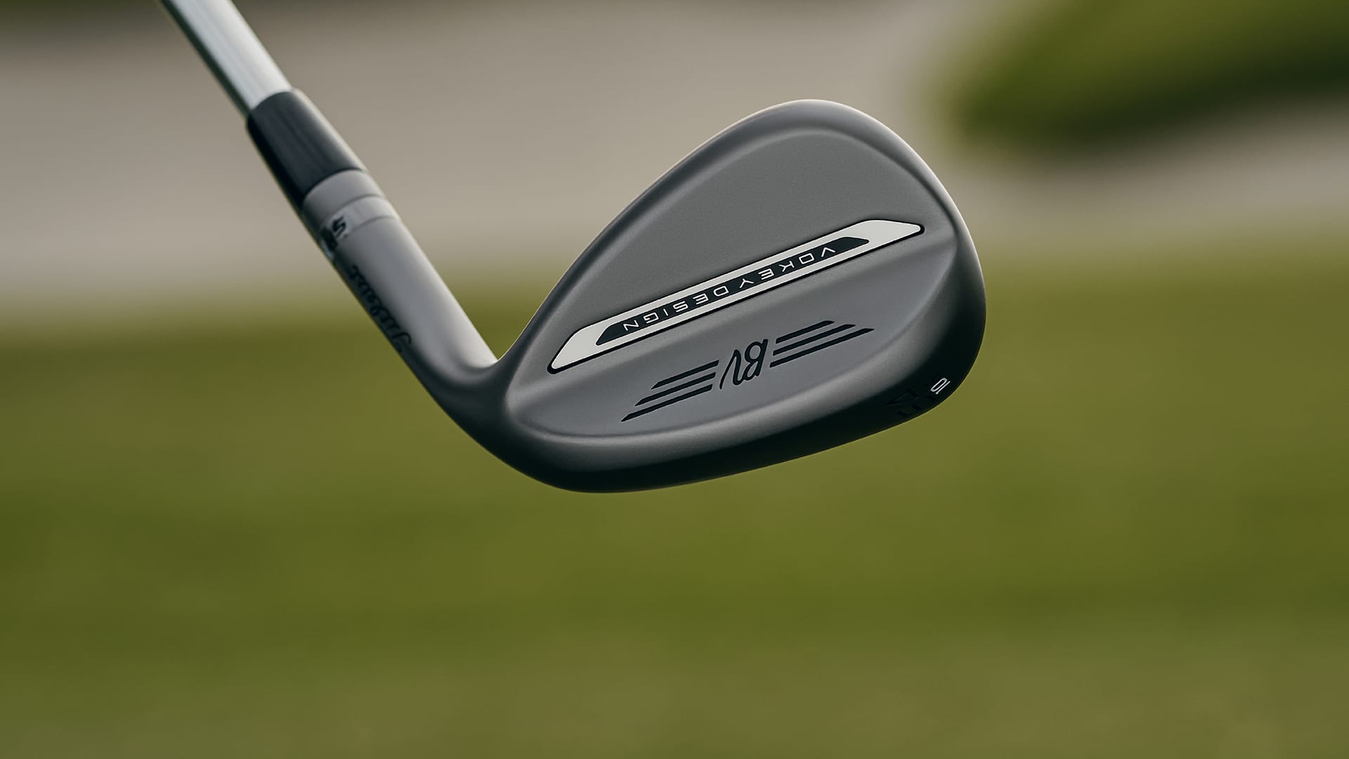 Golf club head with 'Titleist' branding on a blurred golf course background